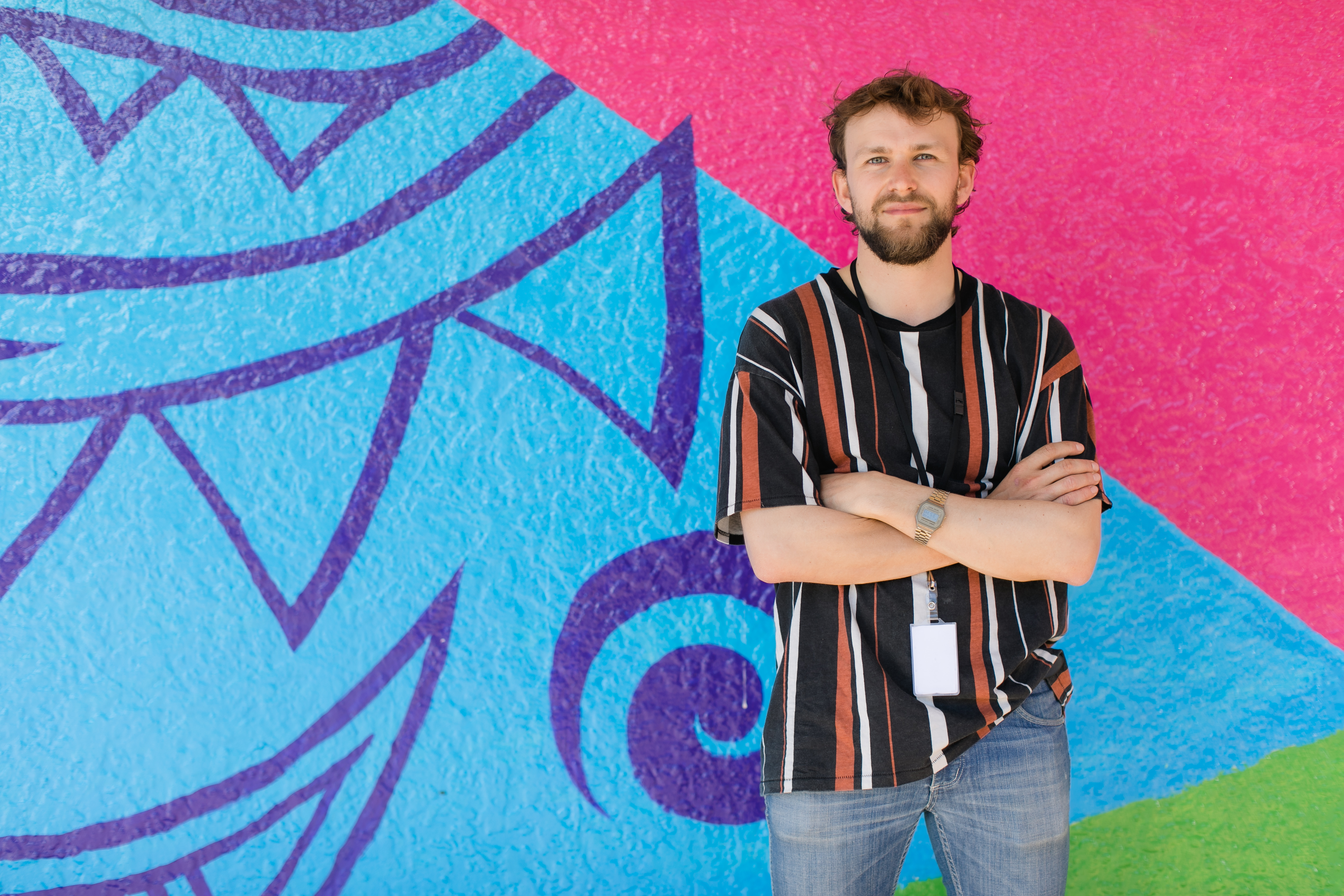 Man in front of mural