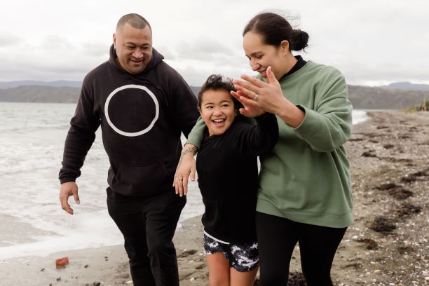 Parents and child walking on the beach