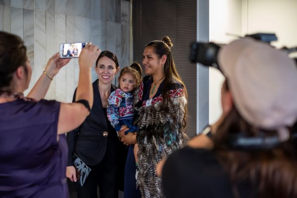 Prime Minister taking a photo with woman and child
