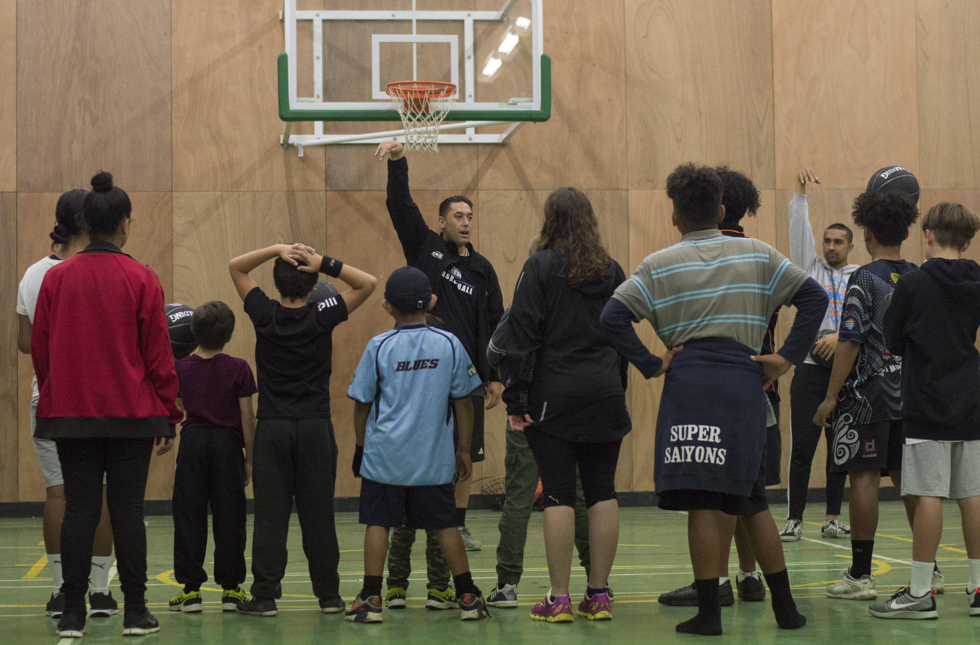 Children of different ages learning basketball